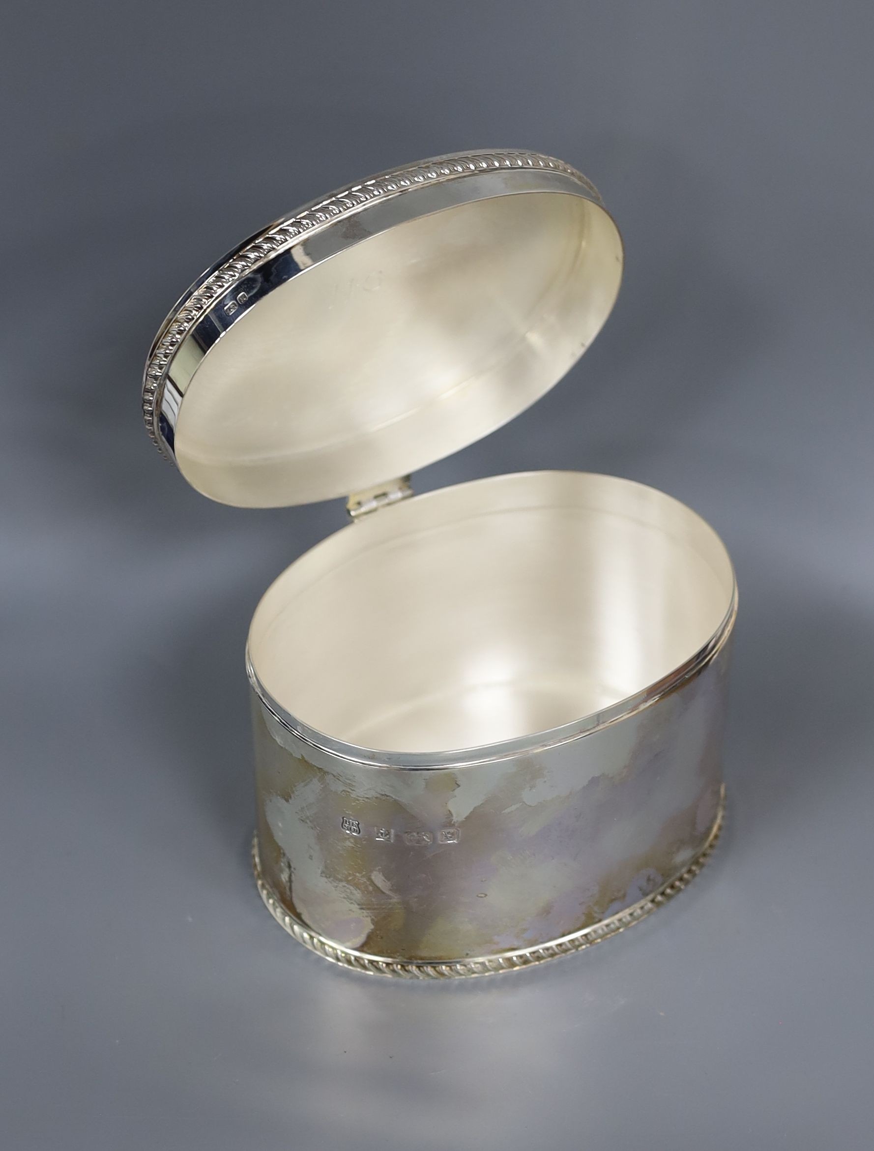 A cased modern silver oval tea caddy, Barker Ellis Silver Co. Birmingham, 1997, length 14cm, 18.5oz, in Gallagher box.